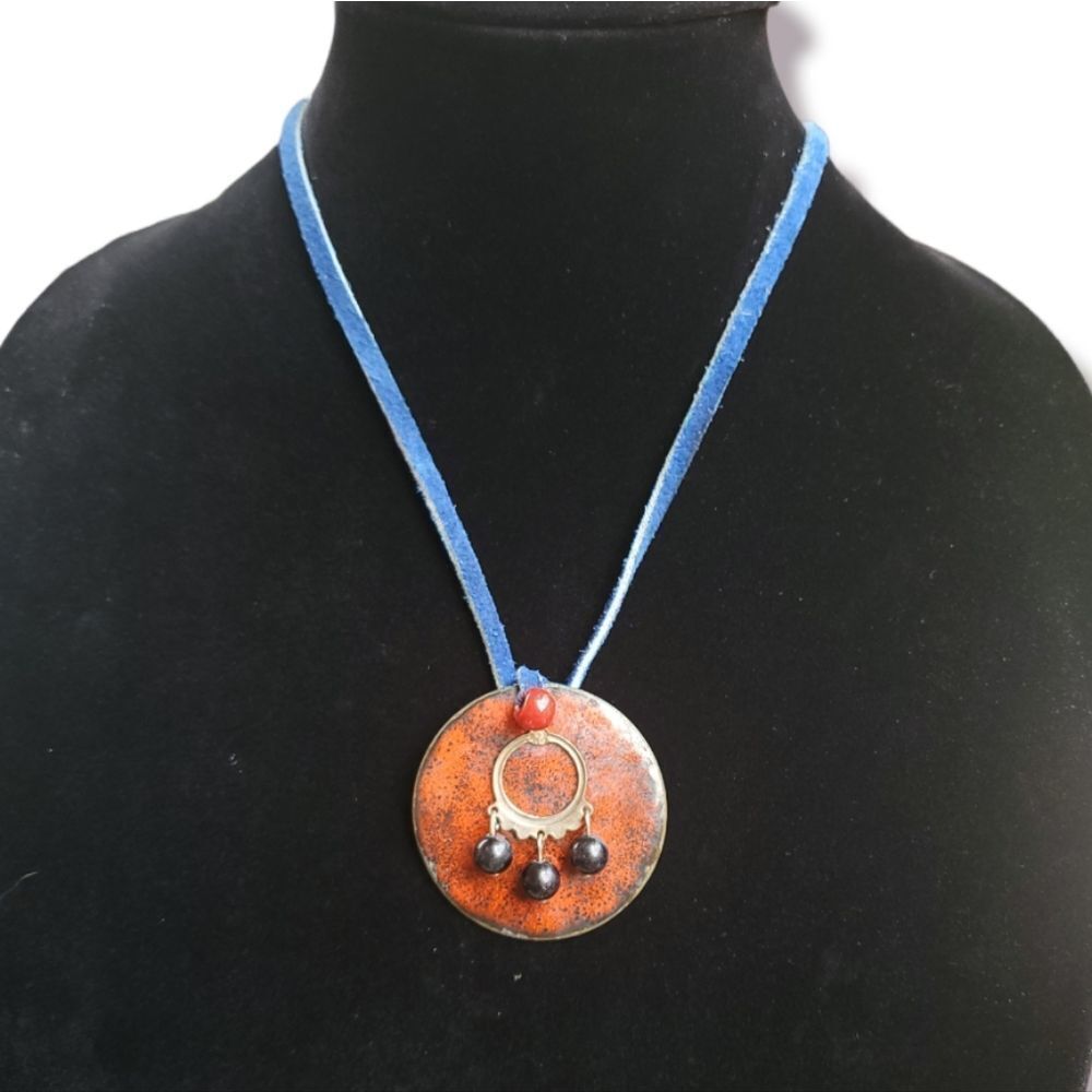 Red medallion pendant with blue leather chain